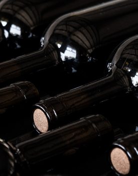 Wine bottles laying down in a rack